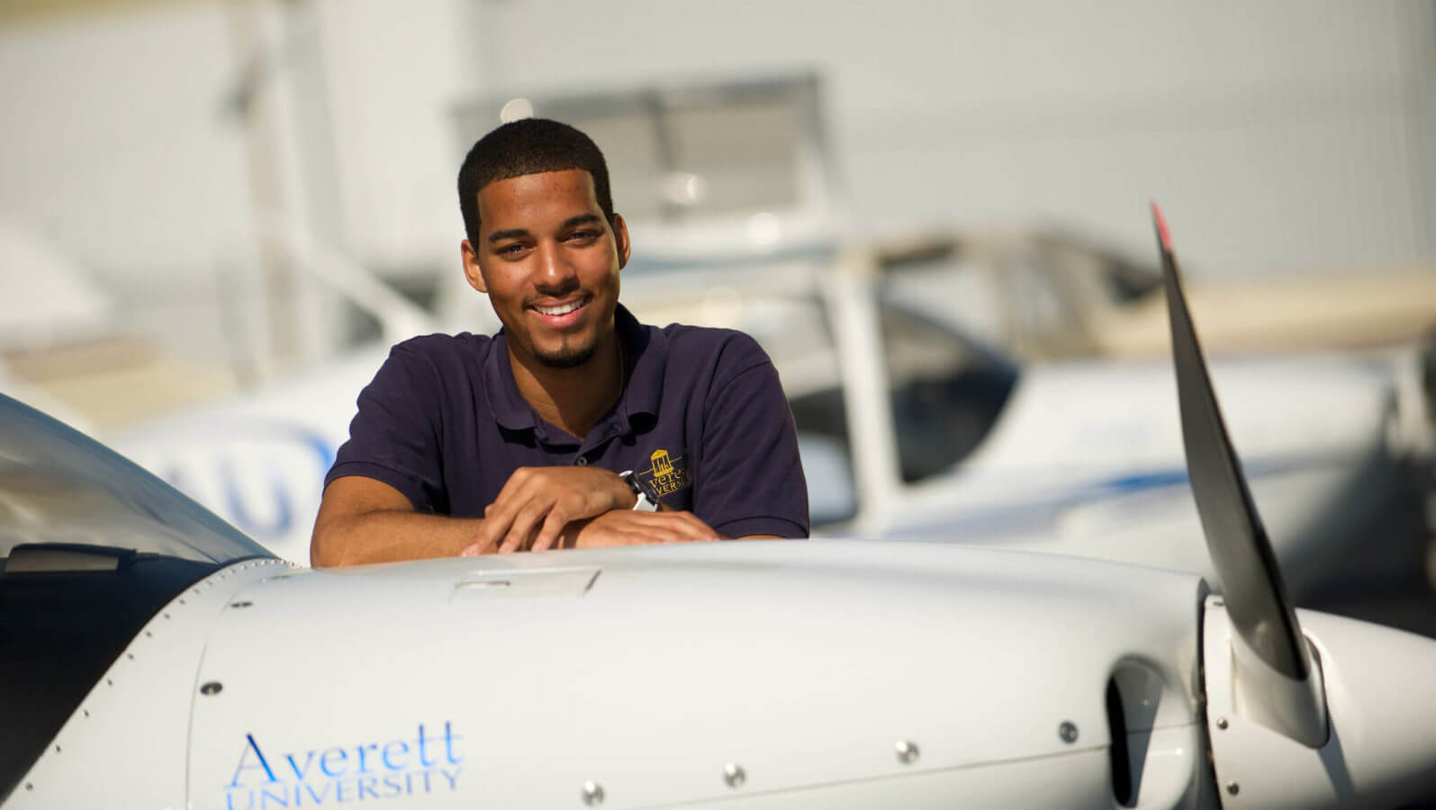 student pilot with plane averett university