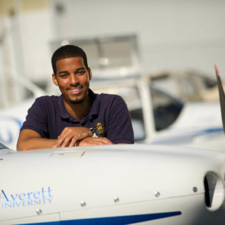 student pilot with plane averett university