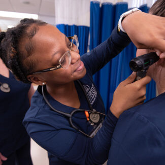 nursing students examining a patient